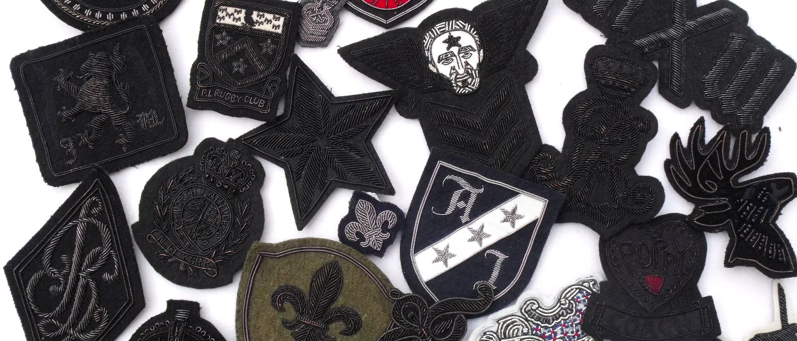 Black bullion crests, stars, wreaths and fleur-de-lis motifs laid out together