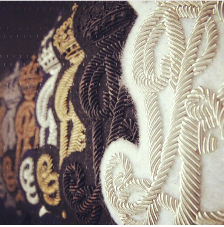 Close detail of gold and silver bullion wirework on felt