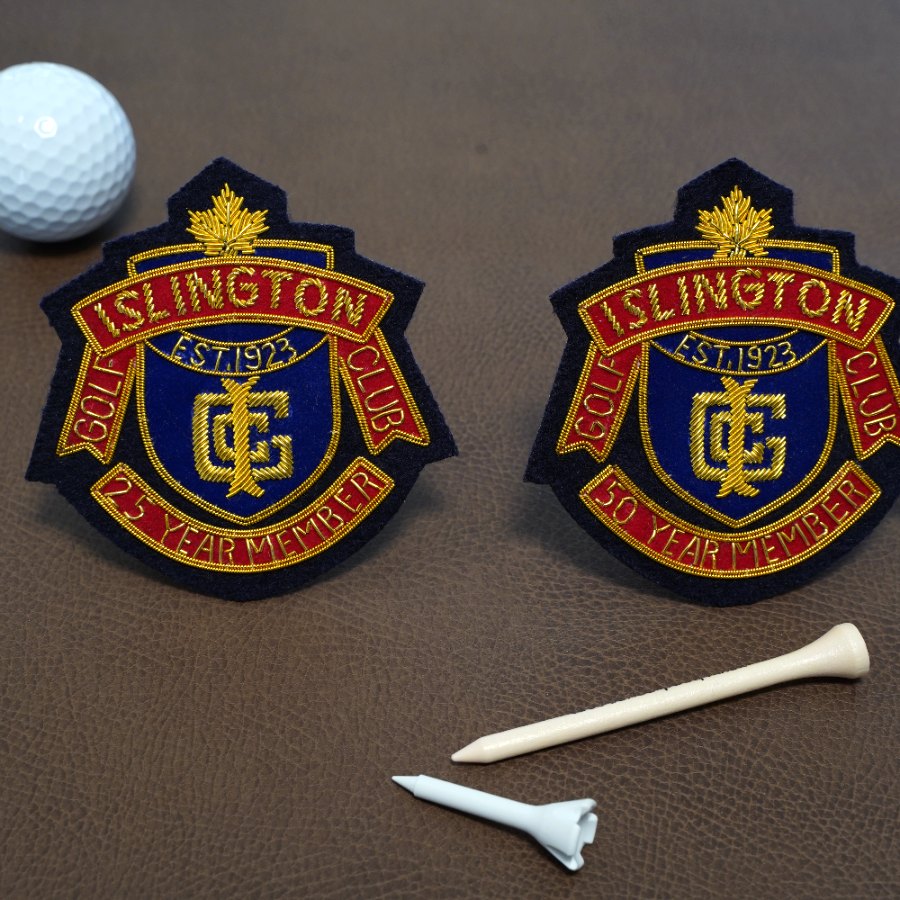 Two Islington Golf Club member crests with a golf ball and tees