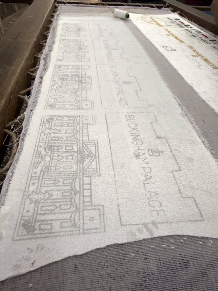 The design traced onto fabric stretched on a wooden frame