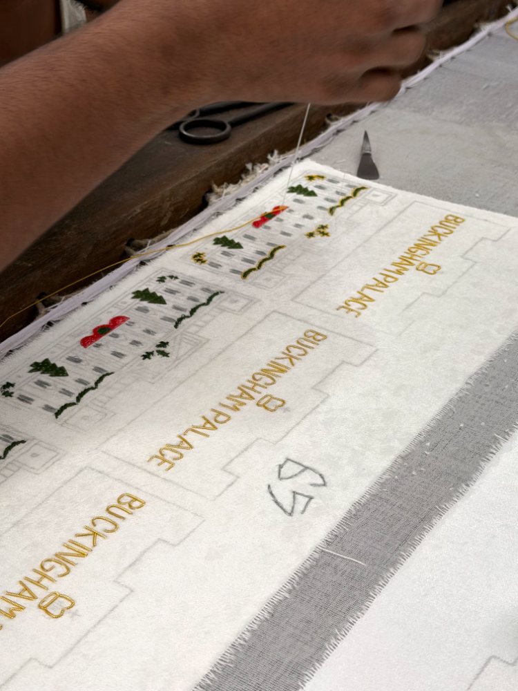 Gold bullion wire being laid along the traced outline by hand
